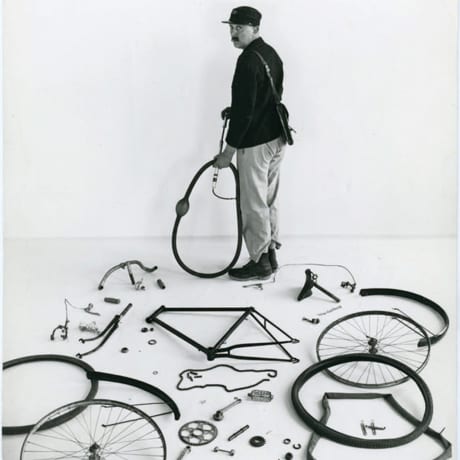 A man and his fully disassembled bike