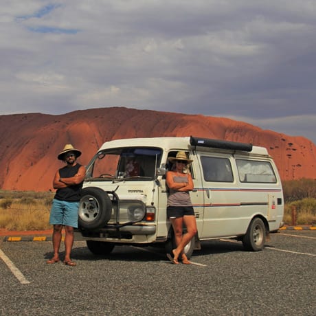 A travelling couple with their van